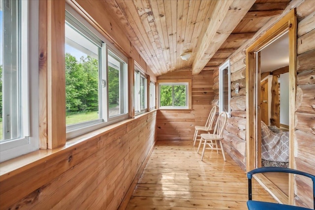 458 Woodcock Rd, Plainfield, VT 05667 - unfurnished sunroom with wood ceiling, hardwood / wood-style flooring, rustic walls, and vaulted ceiling