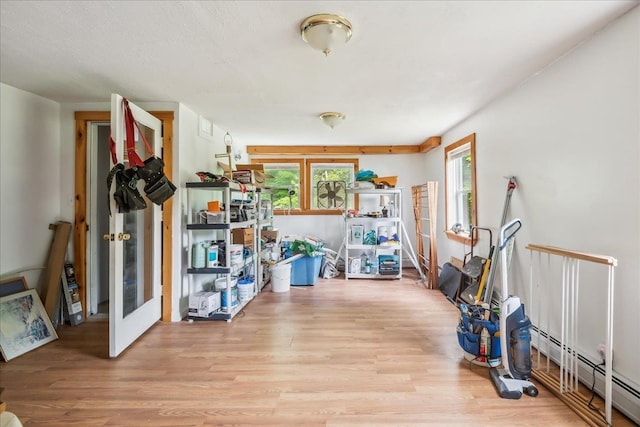 458 Woodcock Rd, Plainfield, VT 05667 - exercise room featuring baseboard heating and wood finished floors