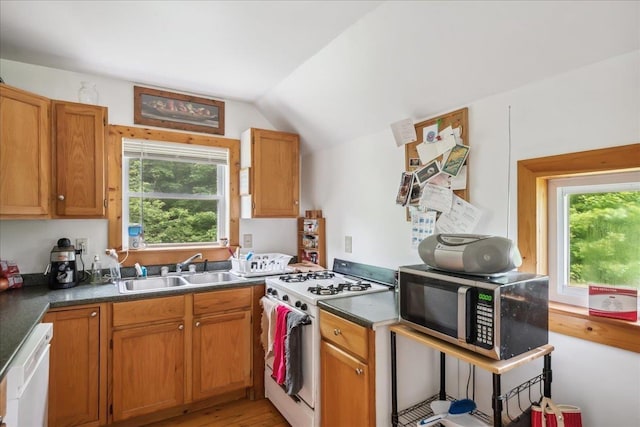 458 Woodcock Rd, Plainfield, VT 05667 - kitchen featuring white appliances, a sink, lofted ceiling, plenty of natural light, and dark countertops