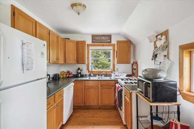 458 Woodcock Rd, Plainfield, VT 05667 - kitchen featuring white appliances, a sink, light wood-style floors, lofted ceiling, and dark countertops