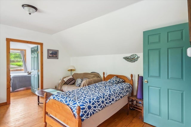 458 Woodcock Rd, Plainfield, VT 05667 - bedroom with light wood-style flooring and lofted ceiling