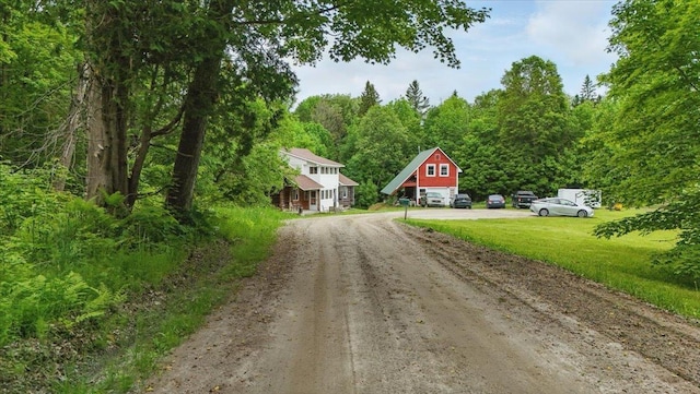 458 Woodcock Rd, Plainfield, VT 05667 - view of dirt / gravel driveway with a forest view