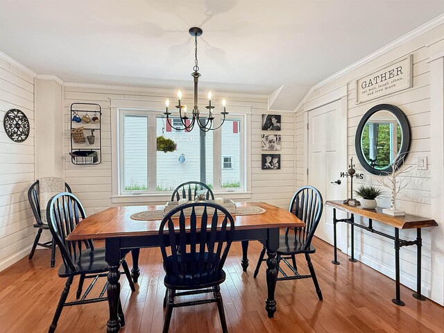 128 Gale St, Canaan, VT 05903 - dining room with crown molding, a chandelier, wood-type flooring, plenty of natural light, and wood walls