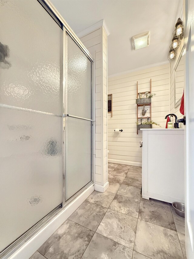 128 Gale St, Canaan, VT 05903 - bathroom with a shower stall, vanity, wood walls, and ornamental molding