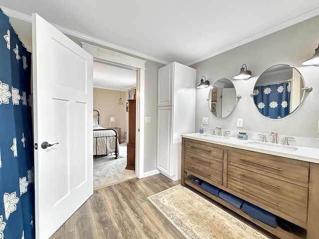 128 Gale St, Canaan, VT 05903 - ensuite bathroom featuring wood finished floors, double vanity, crown molding, and baseboards