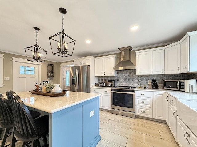 128 Gale St, Canaan, VT 05903 - kitchen with stainless steel appliances, wall chimney range hood, tasteful backsplash, a chandelier, and hanging light fixtures