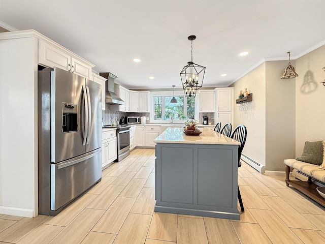 128 Gale St, Canaan, VT 05903 - kitchen featuring stainless steel appliances, a baseboard radiator, wall chimney range hood, white cabinets, and backsplash