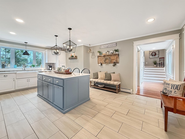 128 Gale St, Canaan, VT 05903 - kitchen with a sink, white cabinetry, light countertops, recessed lighting, and ornamental molding