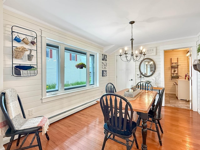 128 Gale St, Canaan, VT 05903 - dining space featuring crown molding, baseboard heating, a chandelier, wood walls, and light wood finished floors