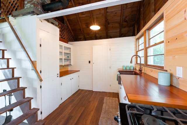 31 Sherene Orchard Rd, Meredith, NH 03253 - kitchen featuring dark wood-style floors, vaulted ceiling, a sink, stovetop, and white cabinets