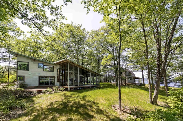 518 Shaker Blvd, Enfield, NH 03748 - view of grassy yard with a sunroom and a deck
