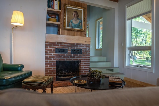 518 Shaker Blvd, Enfield, NH 03748 - living room featuring plenty of natural light and a brick fireplace