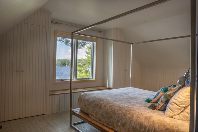 518 Shaker Blvd, Enfield, NH 03748 - bedroom featuring lofted ceiling, hardwood / wood-style floors, and wood walls