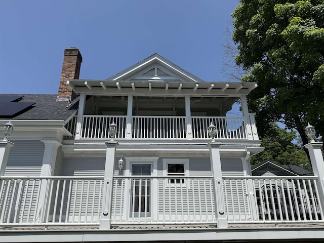 83 Maple St, Morristown, VT 05661 - view of property exterior featuring a balcony and a chimney