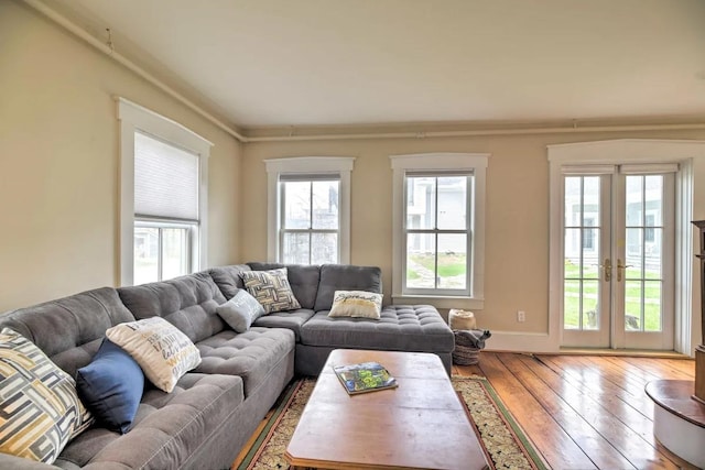 83 Maple St, Morristown, VT 05661 - living area with plenty of natural light, wood-type flooring, french doors, and ornamental molding