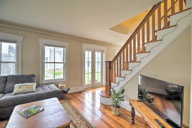 83 Maple St, Morristown, VT 05661 - living area featuring light wood-style flooring, stairway, french doors, baseboards, and ornamental molding