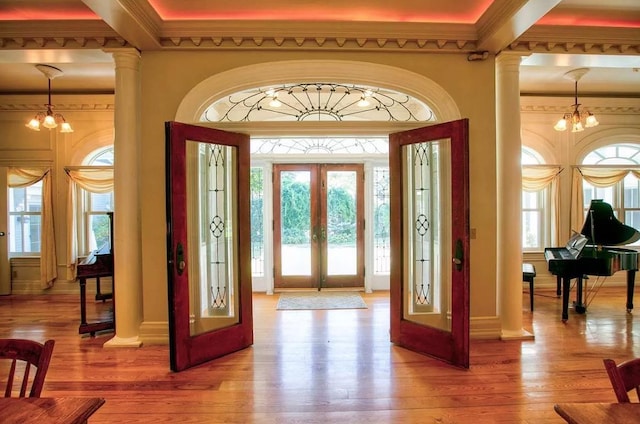 83 Maple St, Morristown, VT 05661 - entryway featuring french doors, hardwood / wood-style floors, decorative columns, and ornamental molding