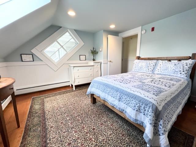 83 Maple St, Morristown, VT 05661 - bedroom featuring a baseboard heating unit, wood finished floors, a skylight, lofted ceiling, and recessed lighting