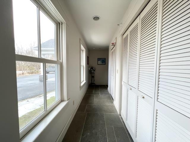 83 Maple St, Morristown, VT 05661 - corridor featuring stone tile floors and baseboards