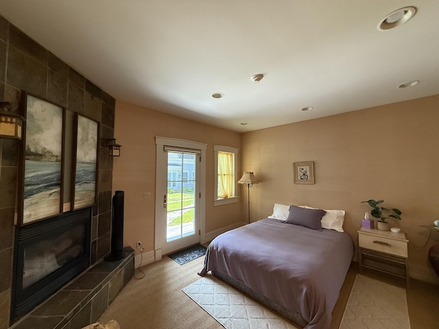 83 Maple St, Morristown, VT 05661 - bedroom with access to exterior, a tiled fireplace, light colored carpet, recessed lighting, and baseboards