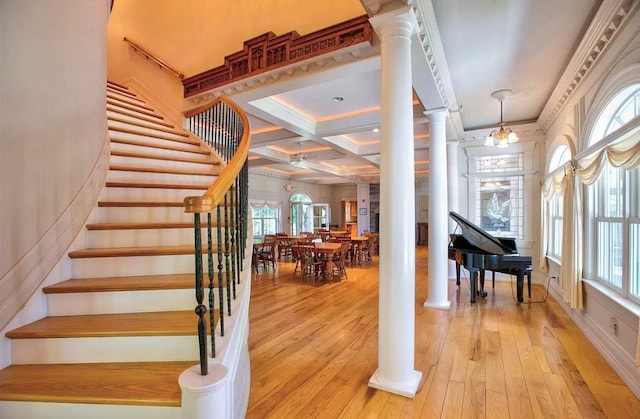 83 Maple St, Morristown, VT 05661 - staircase featuring decorative columns, hardwood / wood-style flooring, coffered ceiling, beamed ceiling, and a chandelier