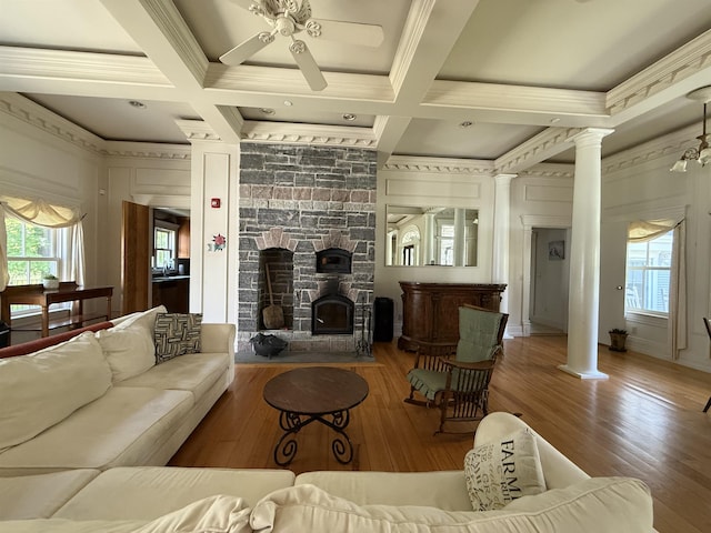 83 Maple St, Morristown, VT 05661 - living room featuring decorative columns, coffered ceiling, a ceiling fan, wood finished floors, and crown molding