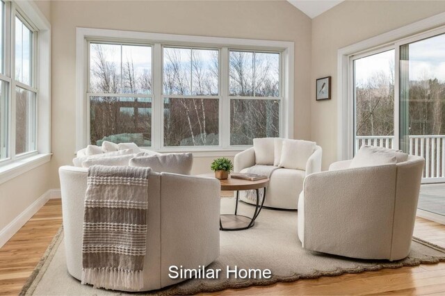 LOT47 Baker Rd Unit 47, Wells, ME 04090 - living area with plenty of natural light, wood finished floors, baseboards, and vaulted ceiling