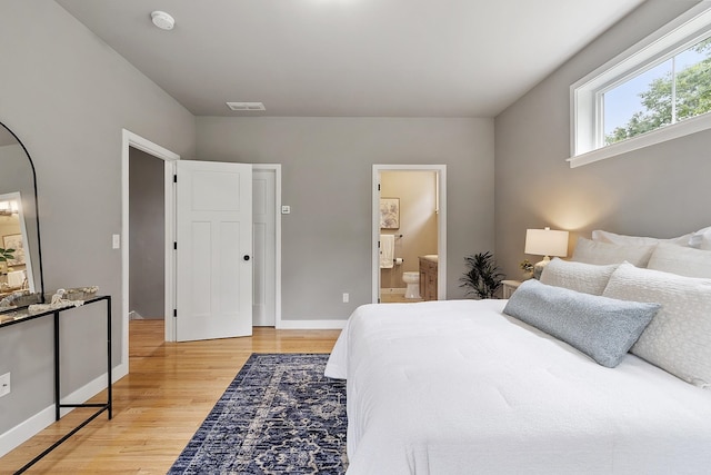 76 Cottonwood Way, Manchester, NH 03102 - bedroom featuring light wood finished floors, baseboards, and ensuite bathroom