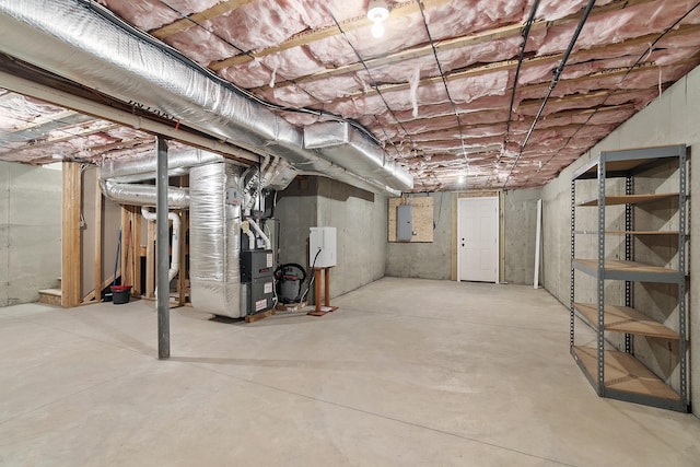 76 Cottonwood Way, Manchester, NH 03102 - unfinished basement featuring heating unit and electric panel