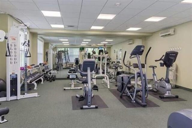76 Cottonwood Way, Manchester, NH 03102 - workout area with a wall mounted air conditioner and a paneled ceiling