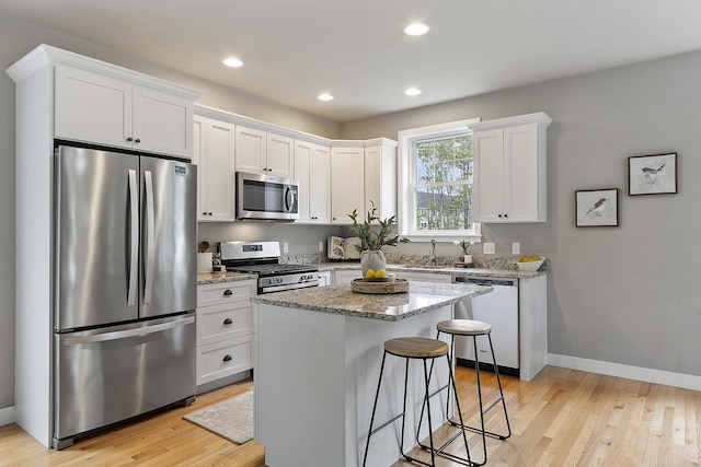 76 Cottonwood Way, Manchester, NH 03102 - kitchen featuring stainless steel appliances, white cabinetry, light wood-style flooring, baseboards, and recessed lighting
