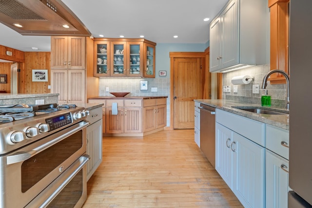 372 Brill Rd, Landaff, NH 03785 - kitchen with appliances with stainless steel finishes, a sink, light stone countertops, decorative backsplash, and premium range hood
