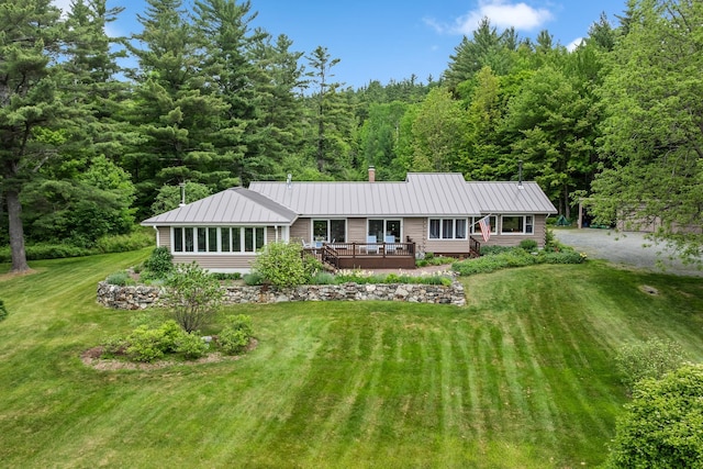 372 Brill Rd, Landaff, NH 03785 - ranch-style house with a wooden deck, a view of trees, a front yard, and metal roof