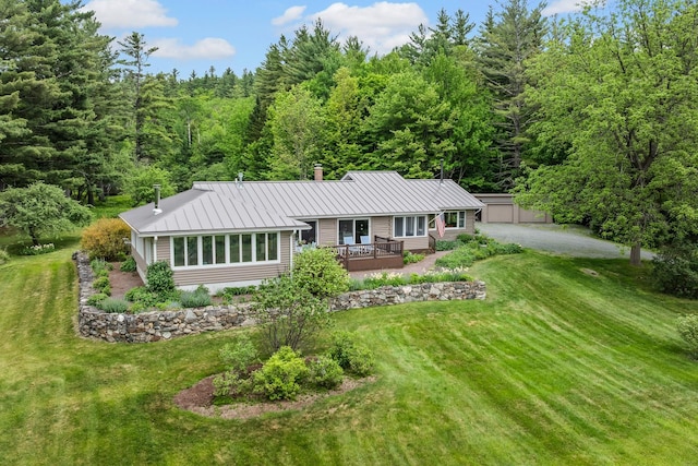 372 Brill Rd, Landaff, NH 03785 - single story home featuring metal roof, a front lawn, a deck, a chimney, and a wooded view