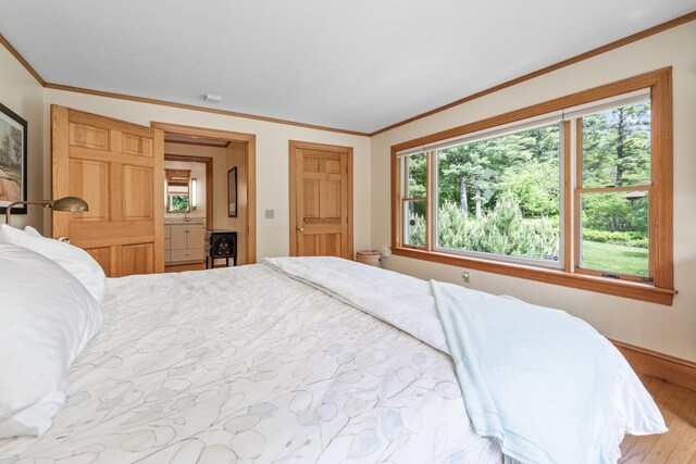 372 Brill Rd, Landaff, NH 03785 - bedroom with multiple windows, ornamental molding, wood finished floors, and baseboards