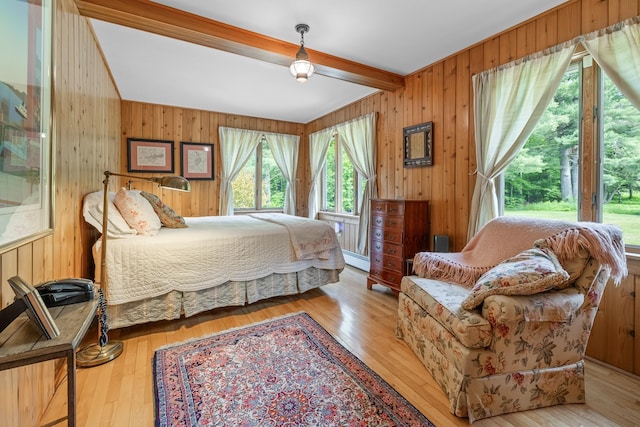 372 Brill Rd, Landaff, NH 03785 - bedroom featuring wooden walls, beamed ceiling, and wood finished floors