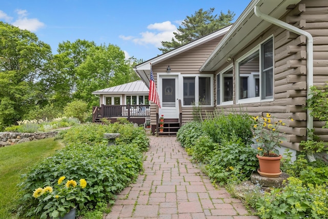 372 Brill Rd, Landaff, NH 03785 - property entrance featuring log siding and a wooden deck