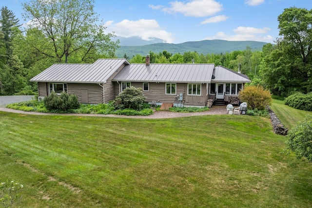 372 Brill Rd, Landaff, NH 03785 - view of front of property featuring a chimney, a front lawn, metal roof, a mountain view, and a standing seam roof