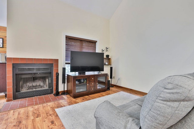 47 Trailside Ln Unit 18, Francestown, NH 03043 - living room with a tiled fireplace, wood finished floors, and high vaulted ceiling