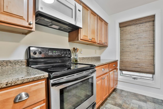 47 Trailside Ln Unit 18, Francestown, NH 03043 - kitchen featuring electric range, white microwave, stone finish flooring, and light countertops
