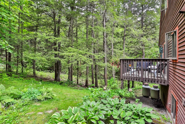47 Trailside Ln Unit 18, Francestown, NH 03043 - view of yard featuring a deck and a wooded view