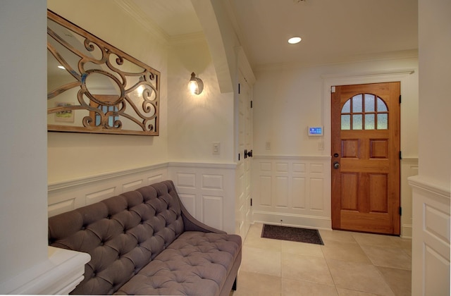 194 Maquam Shore Rd, Swanton, VT 05488 - foyer featuring light tile patterned floors, ornamental molding, wainscoting, and a decorative wall