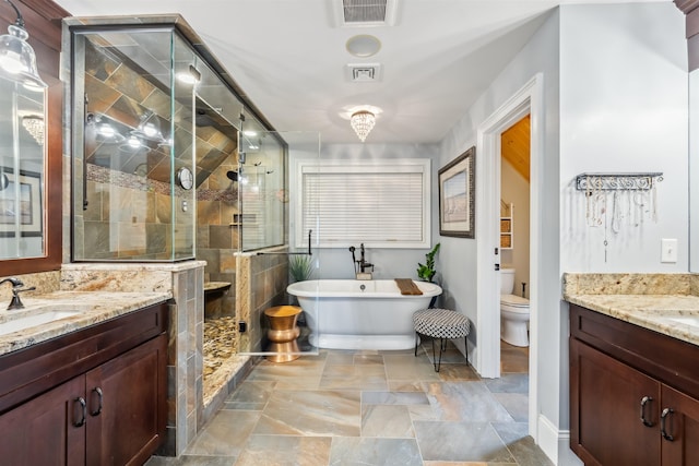 32 Burnham Rd, Windham, NH 03087 - bathroom with two vanities, a stall shower, and a freestanding tub