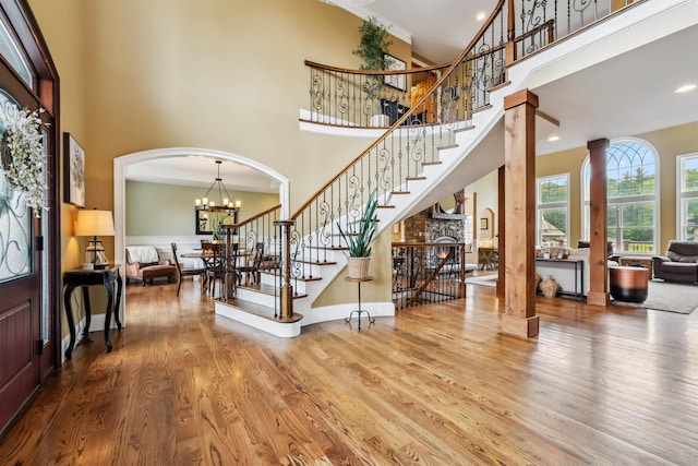 32 Burnham Rd, Windham, NH 03087 - foyer with a towering ceiling, wood finished floors, arched walkways, stairs, and a chandelier