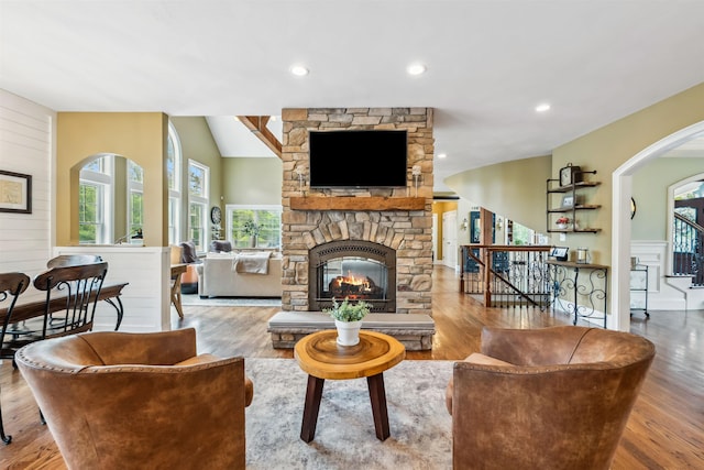 32 Burnham Rd, Windham, NH 03087 - living room with arched walkways, a stone fireplace, wood finished floors, stairway, and recessed lighting