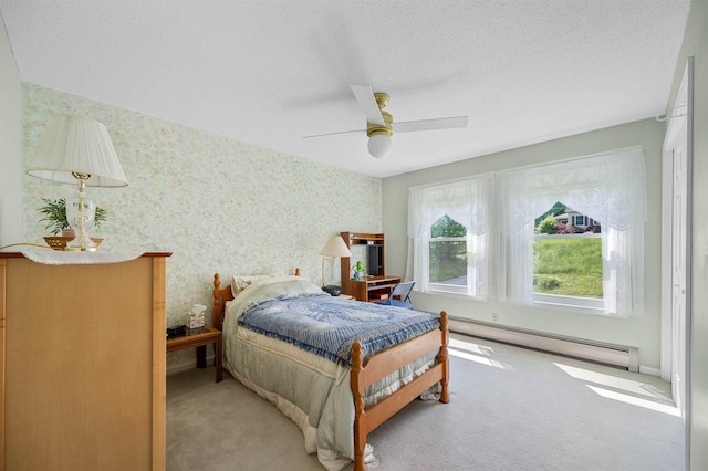 121 Forest Dr Unit 4, Montpelier, VT 05602 - bedroom with a baseboard heating unit, wallpapered walls, carpet, a textured ceiling, and ceiling fan