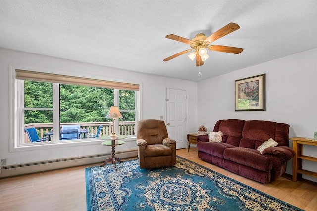 121 Forest Dr Unit 4, Montpelier, VT 05602 - living room featuring baseboard heating, ceiling fan, wood finished floors, and a textured ceiling
