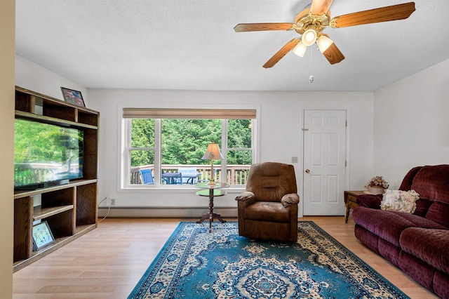 121 Forest Dr Unit 4, Montpelier, VT 05602 - living area with baseboard heating, wood finished floors, a ceiling fan, and a textured ceiling