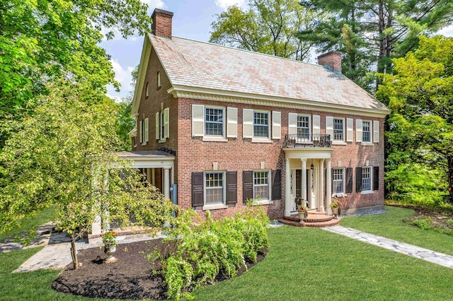 84 S Main St, Hanover, NH 03755 - colonial house featuring a chimney, a high end roof, a front yard, and brick siding