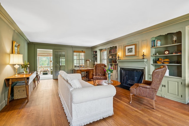84 S Main St, Hanover, NH 03755 - living area with ornamental molding, a fireplace with flush hearth, wood finished floors, and built in features